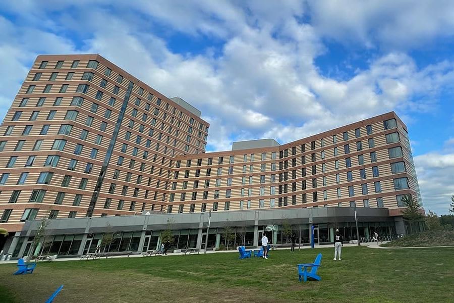 Residence Hall with students on lawn in front.